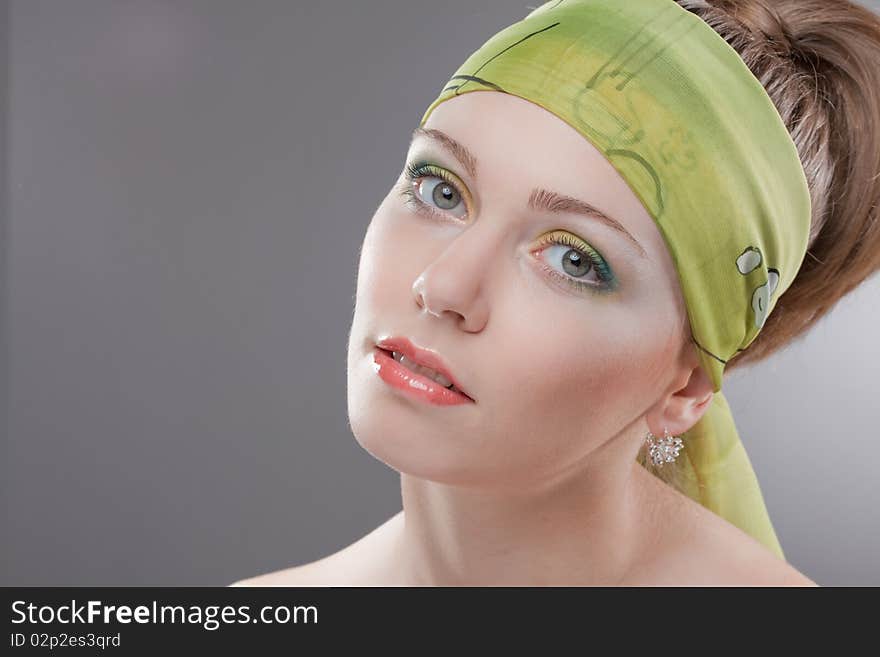 young woman in colored scarf on head