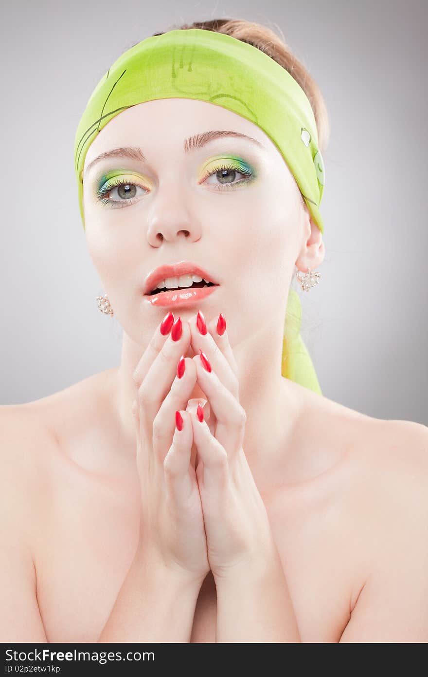 Closeup portrait of young woman with beautiful eyes holding hands near face