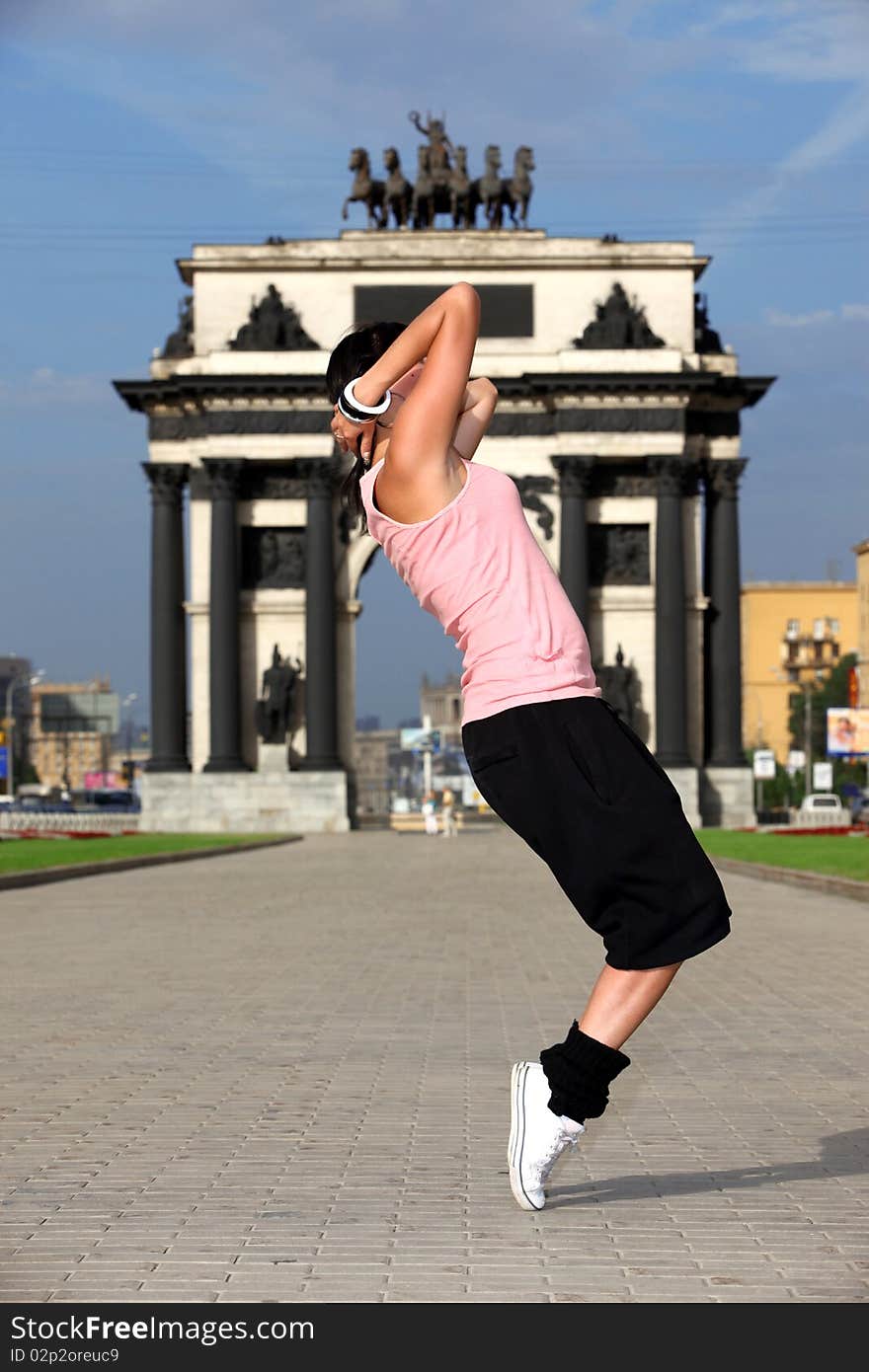 Woman modern ballet dancer in city against classic arch