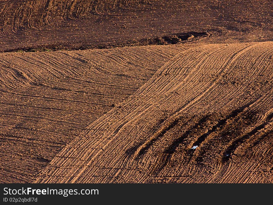 The freshly ploughed brown field. The freshly ploughed brown field