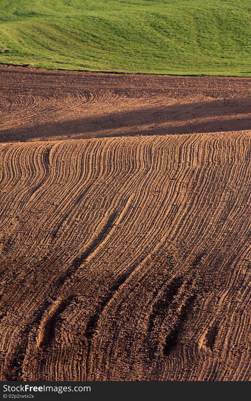 The freshly ploughed brown field. The freshly ploughed brown field