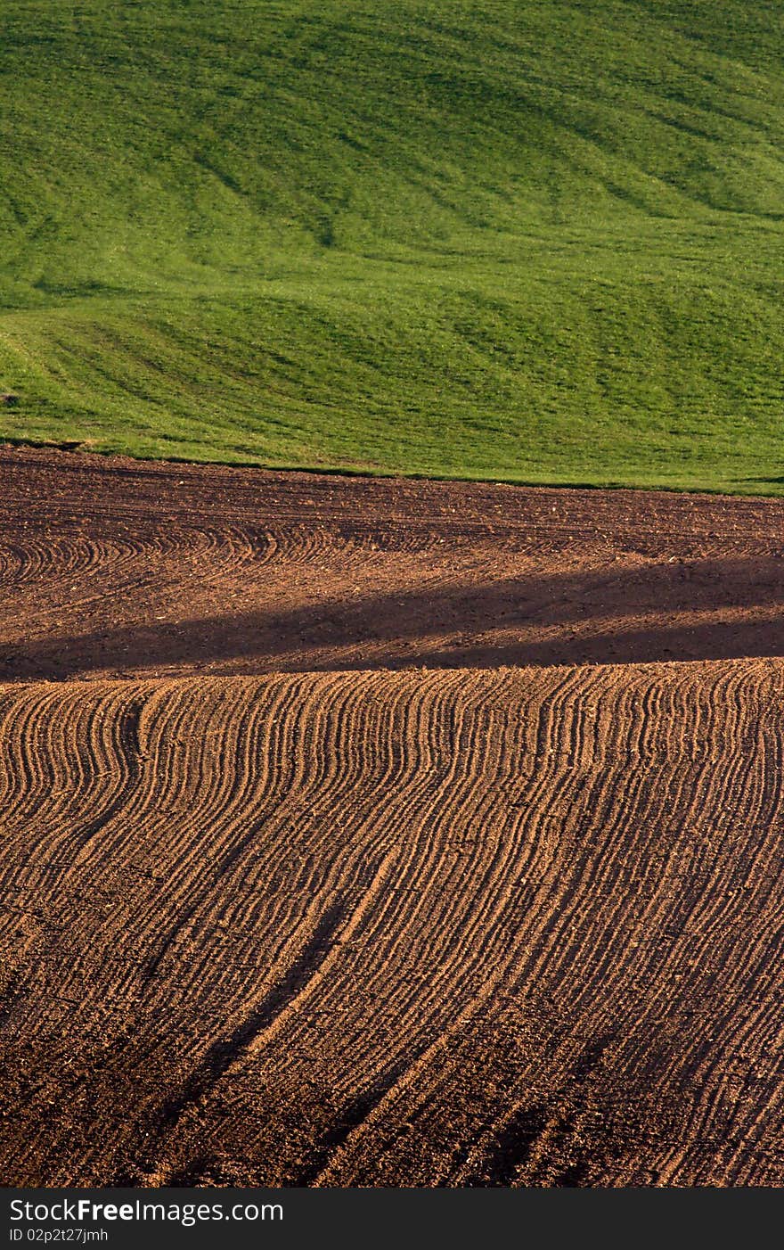 The freshly ploughed brown field. The freshly ploughed brown field