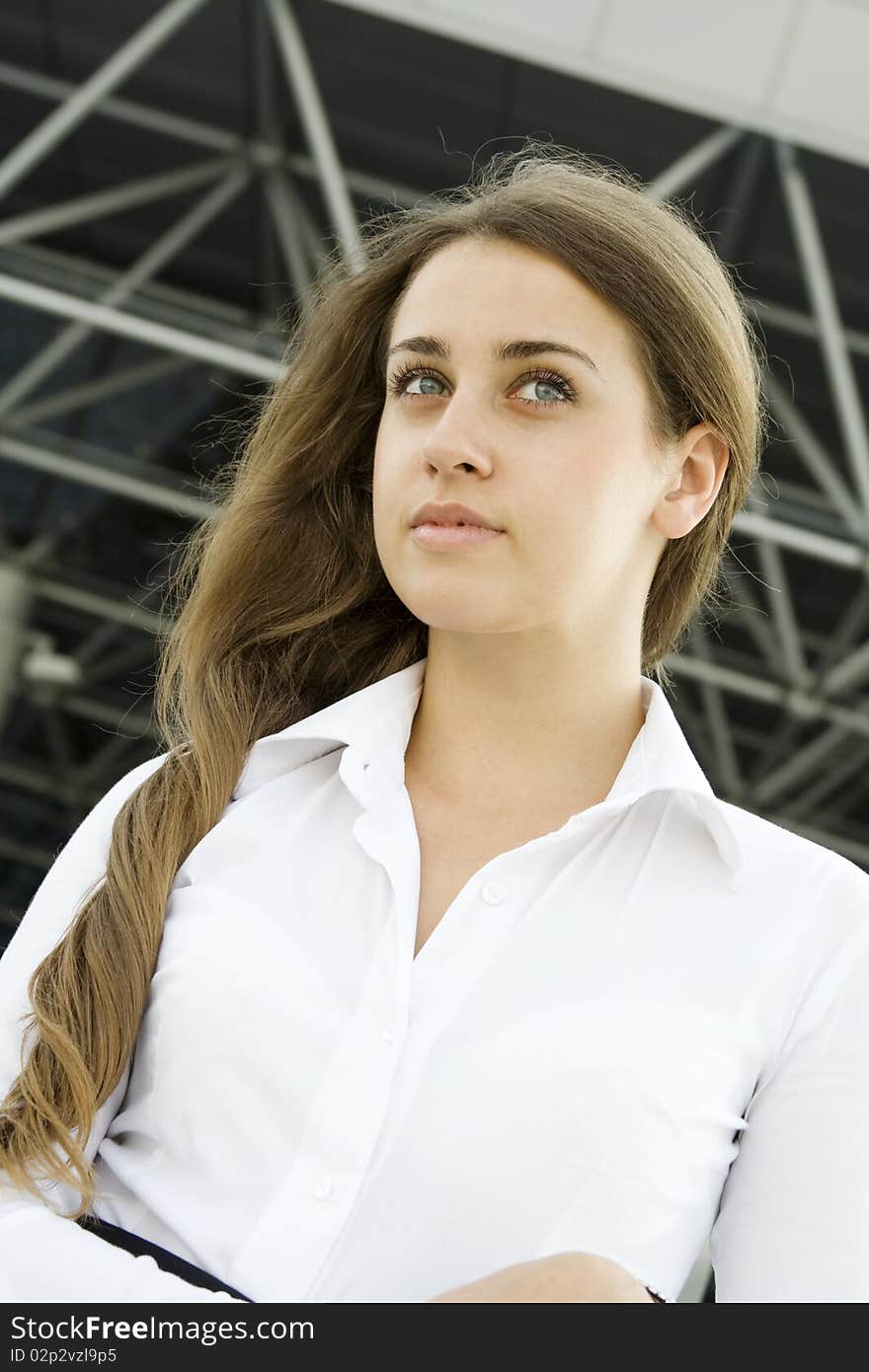 Contemporary portrait of a young professional business women to consider against the background of office space. Contemporary portrait of a young professional business women to consider against the background of office space