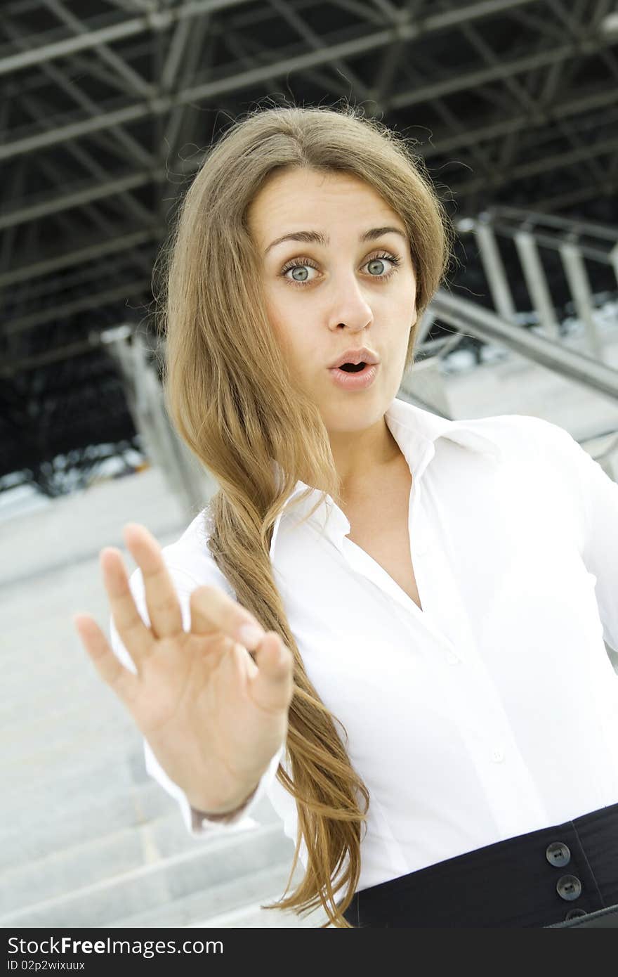 Young business woman shows a sign of OK. Emotions. Surprise. Young business woman shows a sign of OK. Emotions. Surprise