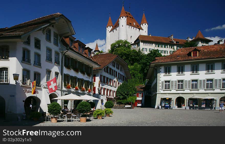 A view from the market square, with the castle in the back, of the old Swiss town of Thun on the Aare River.