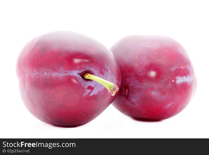 Two plums isolated over white