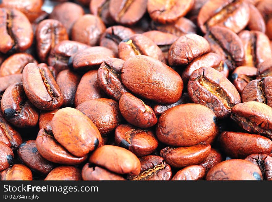 Black roasted coffee beans background. Black roasted coffee beans background