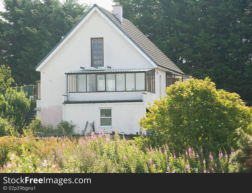 An image of a house being built with a sun room over the garage and workshop. An image of a house being built with a sun room over the garage and workshop.