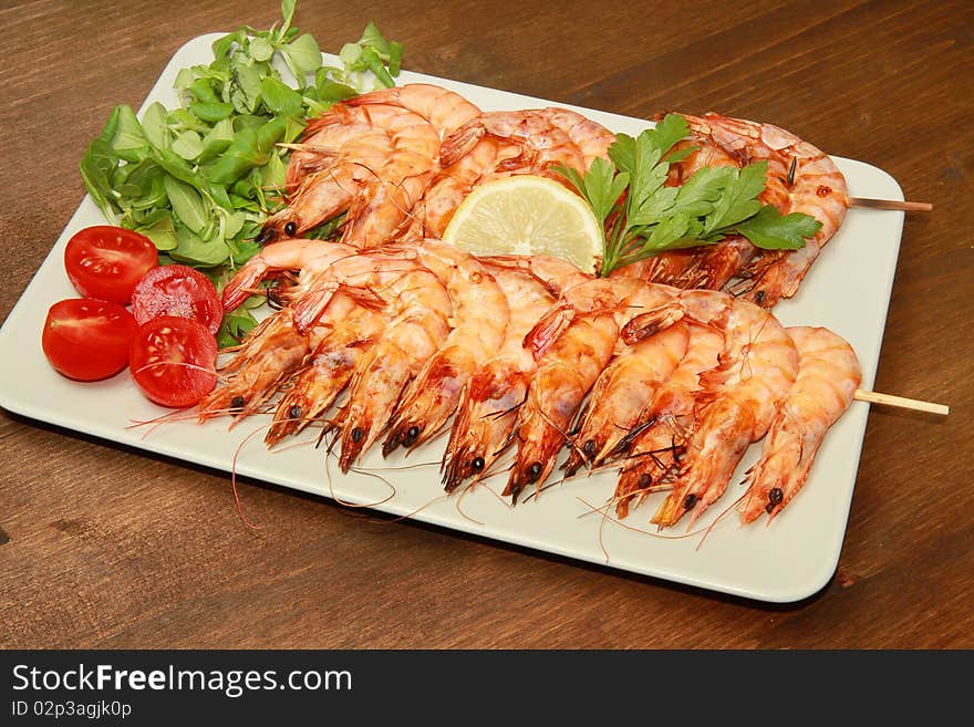 A dish with grilled shrimps