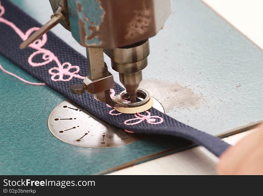 Closeup of needle and thread on sewing machine