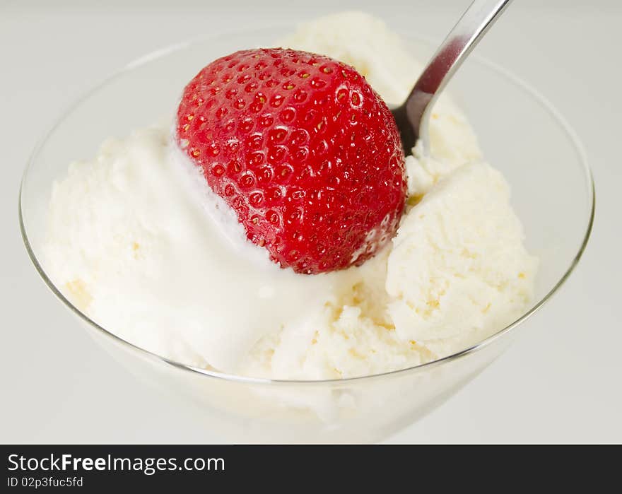 Ice-cream vanilla with stawberrie and spoon in glass. Ice-cream vanilla with stawberrie and spoon in glass