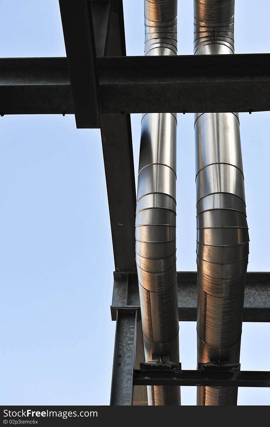 Two aluminium pipes make their way through  a maze of steel bars in the former Philips factoy area in Eindhoven. Two aluminium pipes make their way through  a maze of steel bars in the former Philips factoy area in Eindhoven