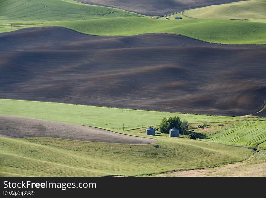 A farm is dwarfed by the vast size of the Palouse fields in eastern. A farm is dwarfed by the vast size of the Palouse fields in eastern