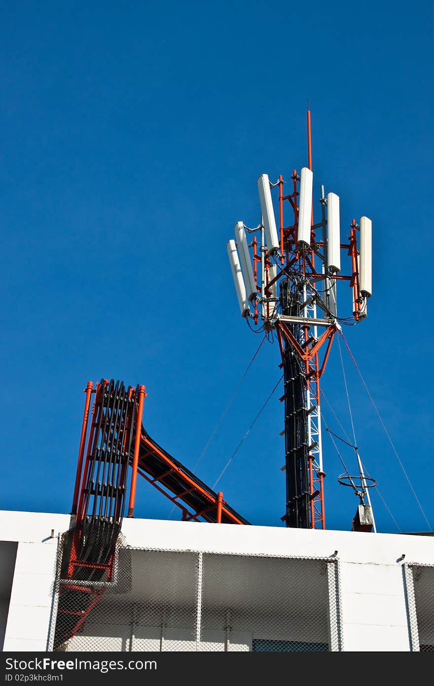 Cellphone Transmitter over the roof of building in Khon Kaen, Thailand.