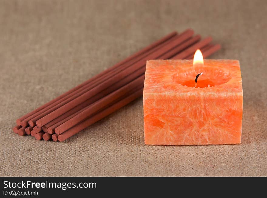 A bundle of incense sticks and a candle