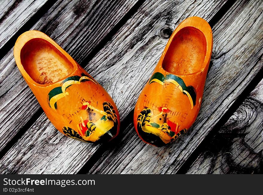 Traditional wooden holland clogs on wooden background