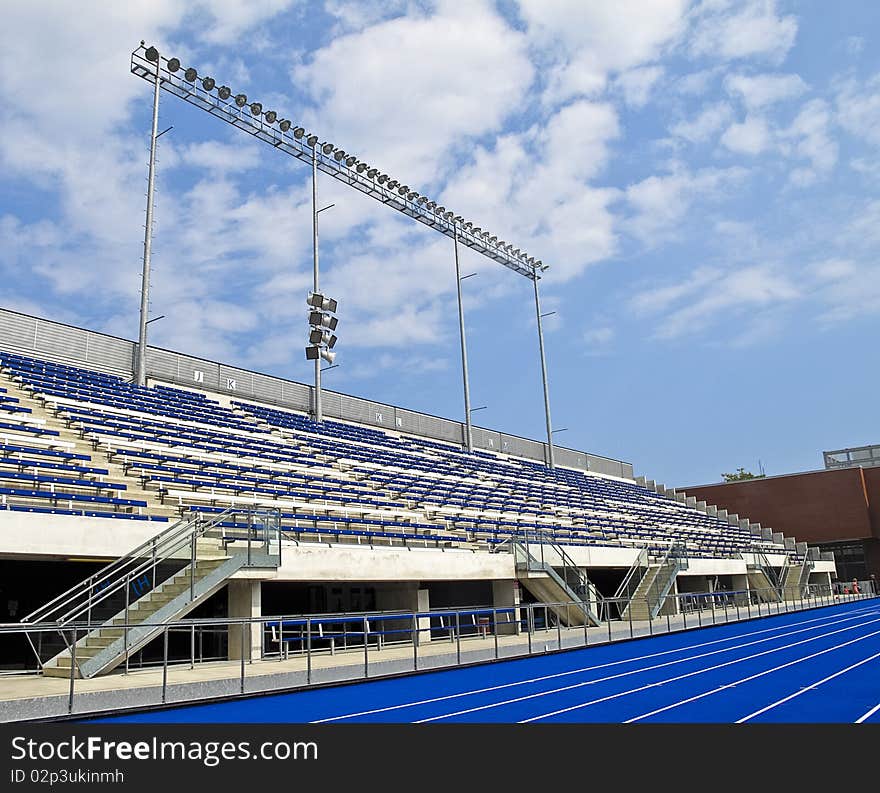 Stands and lighting in outdoor stadium shot on sunny day