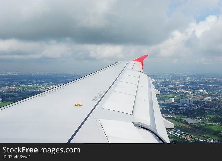 Travel view from airplane showing wing during flight over bangkok thailand. Travel view from airplane showing wing during flight over bangkok thailand