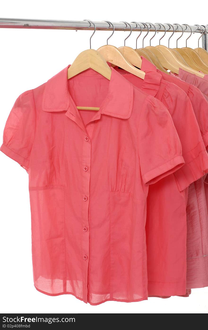 View of red t shirts hanging on a clothesline.