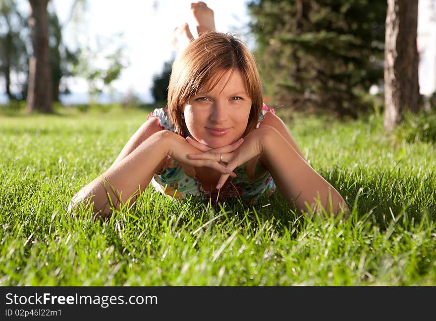 The girl having a rest on a grass