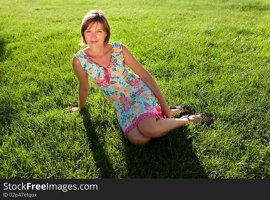 The girl having a rest on a grass in a sunny day. The girl having a rest on a grass in a sunny day