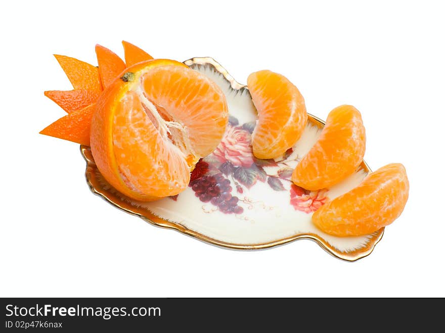 Orange tangerine devided into segments and decorated with peel on beauty fruit dish. Isolated on white background. Orange tangerine devided into segments and decorated with peel on beauty fruit dish. Isolated on white background