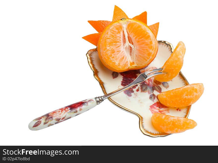 Orange tangerine devided into segments and decorated with peel on beauty fruit dish with fork. Isolated on white background. Orange tangerine devided into segments and decorated with peel on beauty fruit dish with fork. Isolated on white background