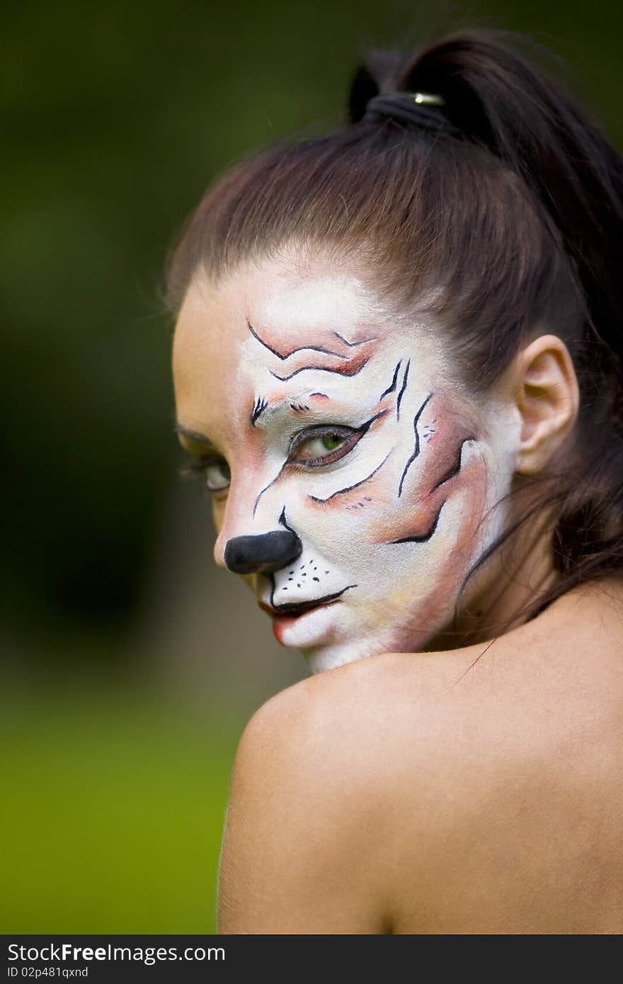 Young woman with tigress face art