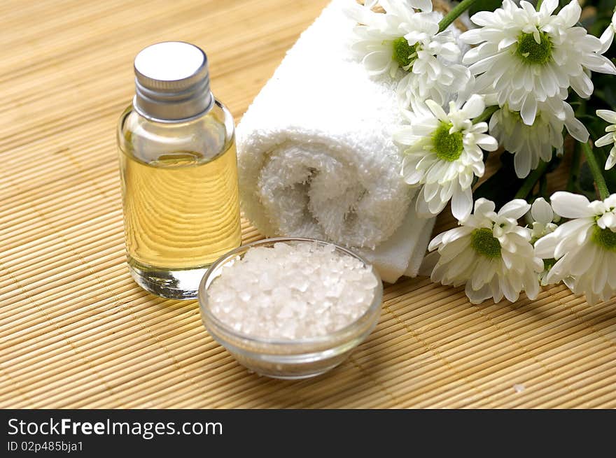 Spa composition. Towel, candle and chrysanthemums. Spa composition. Towel, candle and chrysanthemums