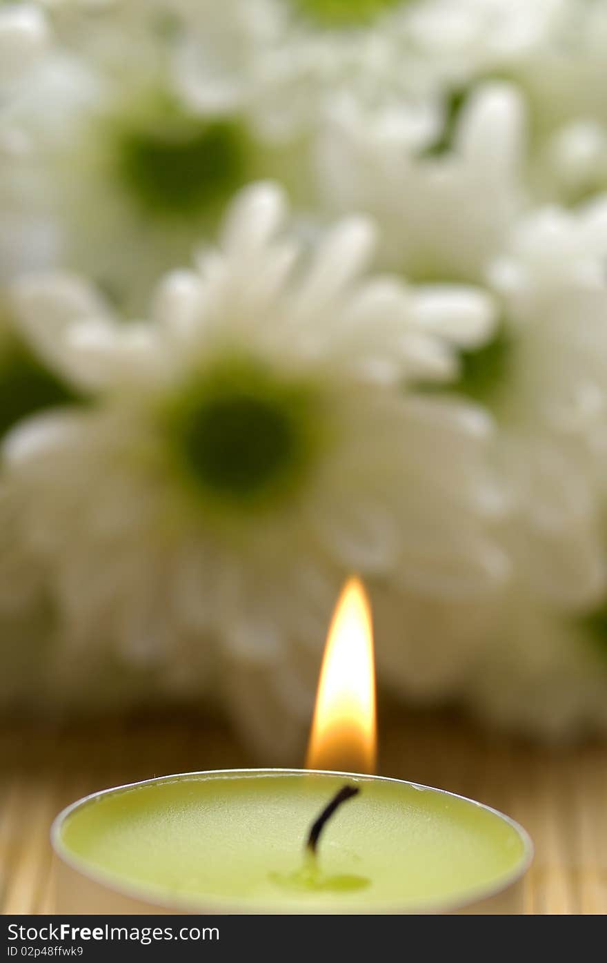 Candle and daisy on mat. Candle and daisy on mat