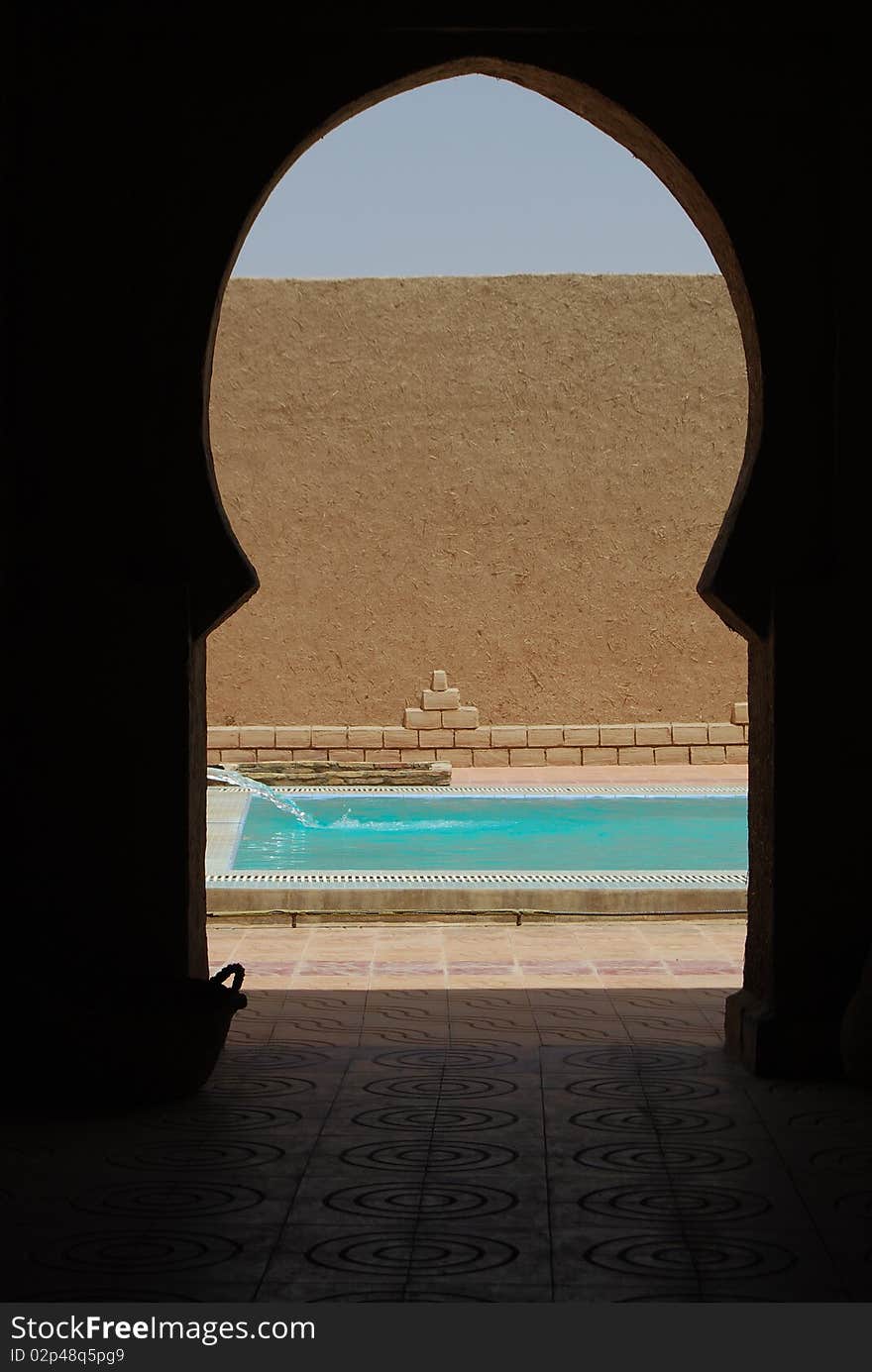 Water pours into a swimming pool in a desert hotel. Water pours into a swimming pool in a desert hotel.