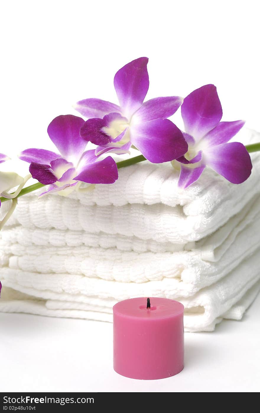 White towel and pink orchids flower and candle. White towel and pink orchids flower and candle