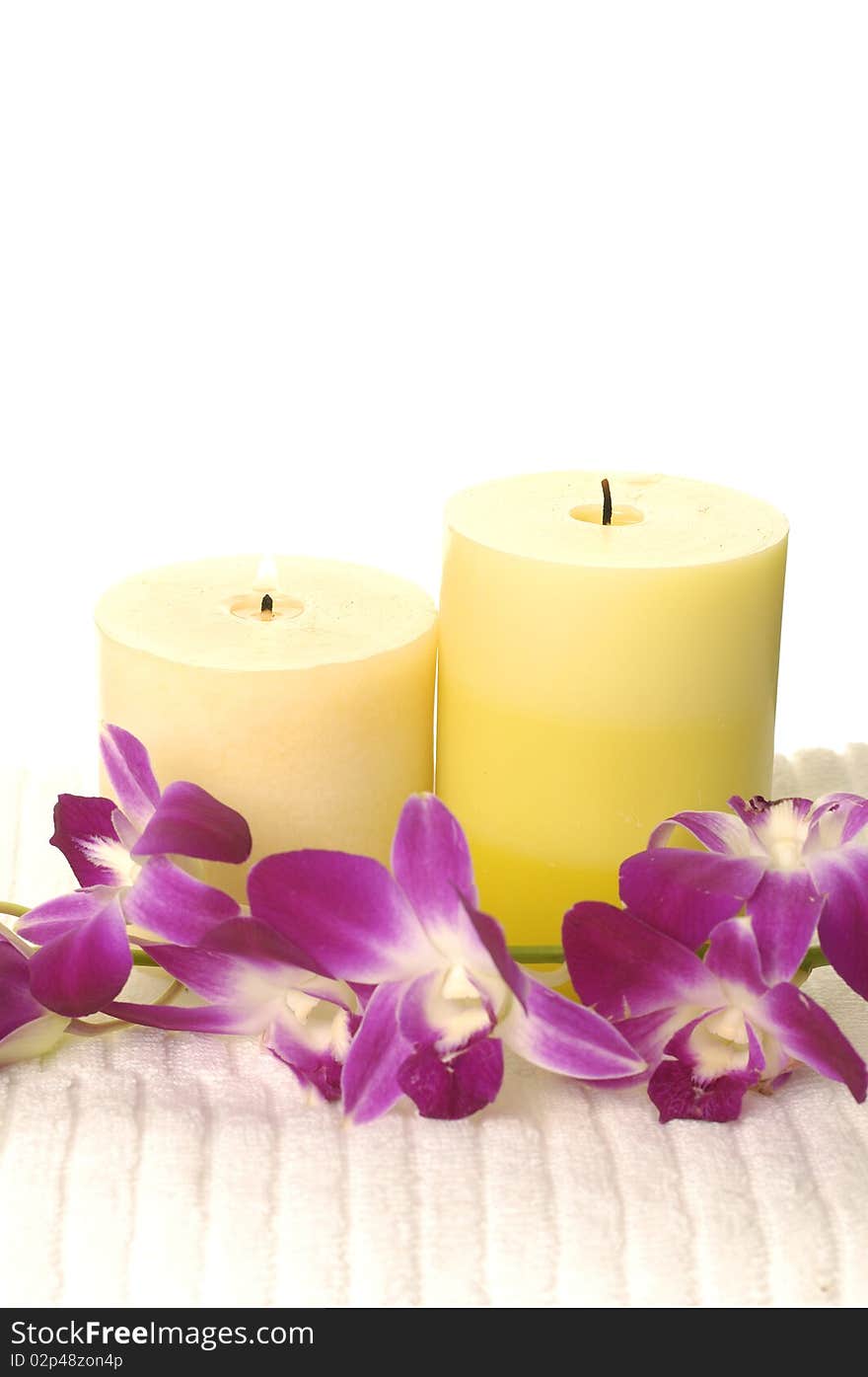 Pink orchid Flower and candles on white. Pink orchid Flower and candles on white