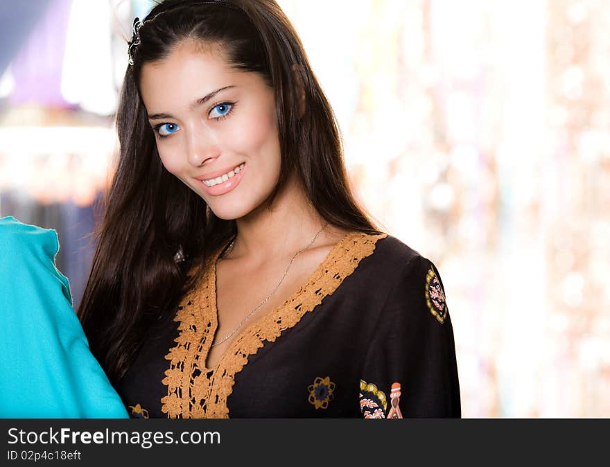 Long-haired girl with smile is shopping. Long-haired girl with smile is shopping