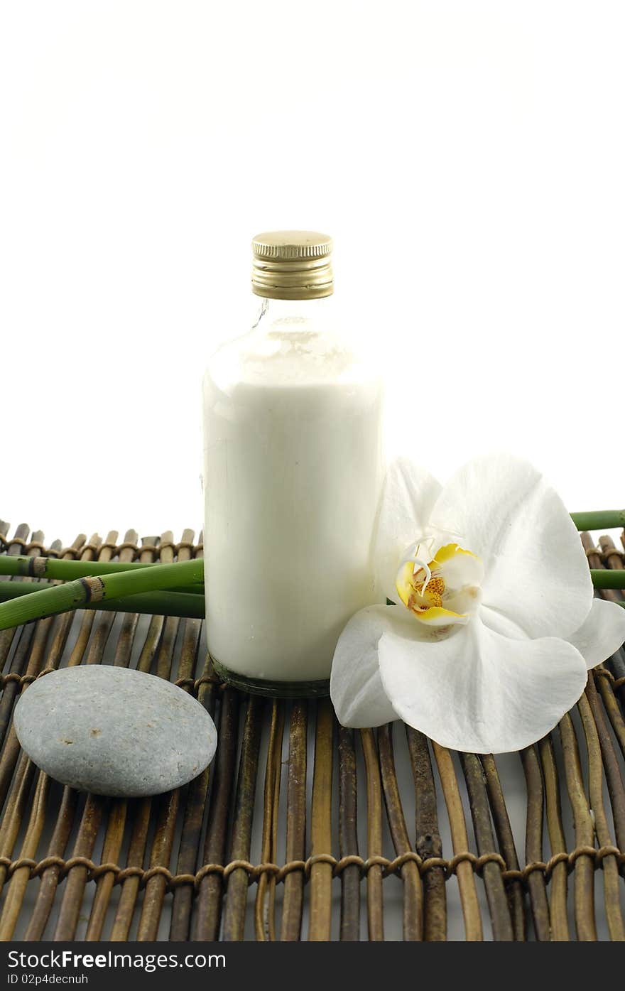 Wooden bowl of towel and orchid on mat. Wooden bowl of towel and orchid on mat