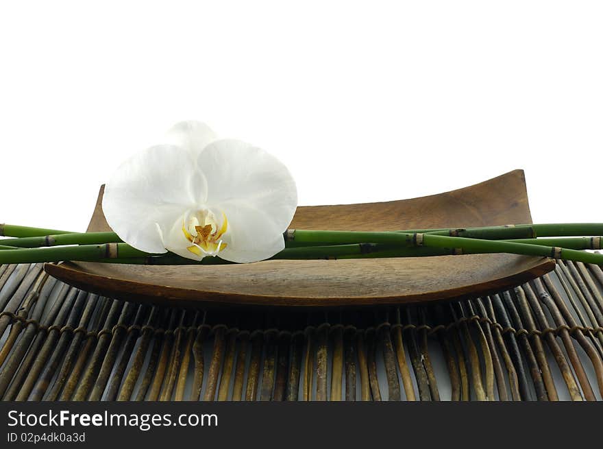 Wooden bowl of orchid on mat. Wooden bowl of orchid on mat