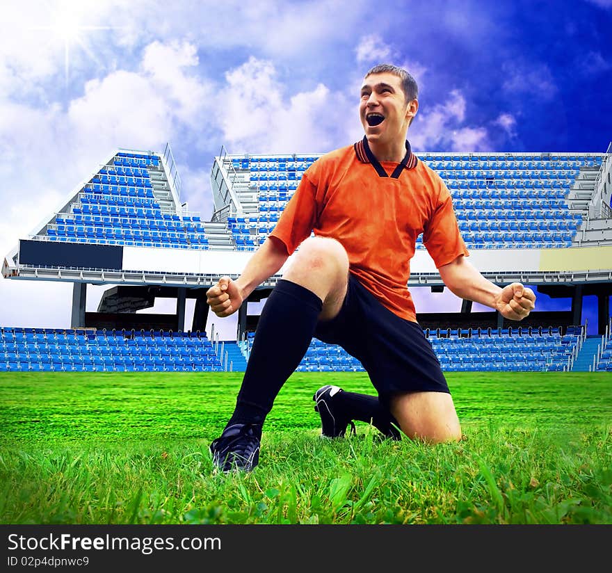 Happiness football player after goal on the field of stadium with blue sky. Happiness football player after goal on the field of stadium with blue sky