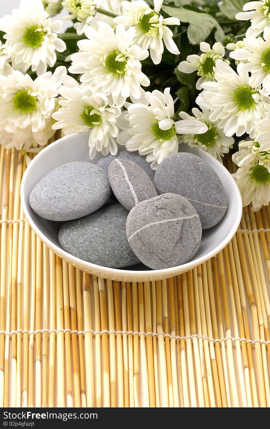 Bowl of pebbles with Chrysanthemums flowers. Bowl of pebbles with Chrysanthemums flowers