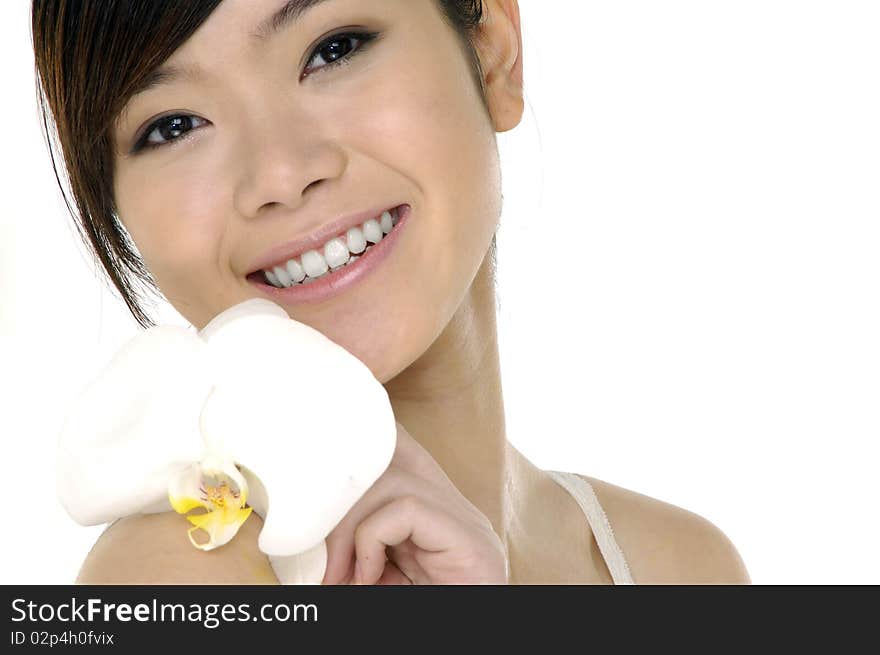 Beautiful girl holding orchid flower in her hands