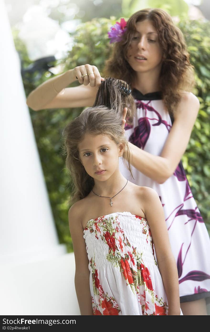 Portrait of happy mother with daughter having good time in summer environment. Portrait of happy mother with daughter having good time in summer environment