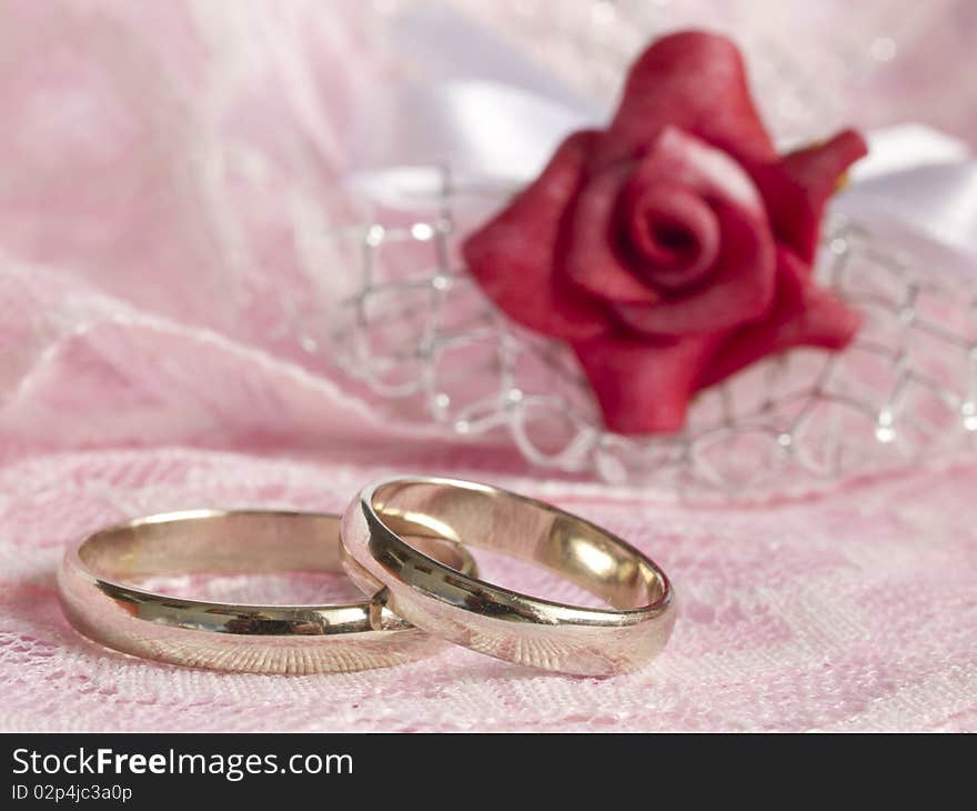 With white gold rings and red rose. With white gold rings and red rose