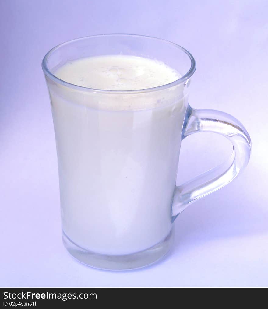 Milk in a glass on a blue background