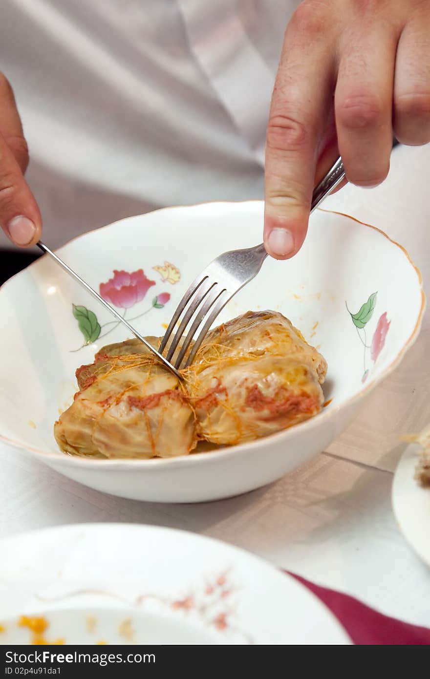 Man eating traditional stuffed cabbage. Man eating traditional stuffed cabbage