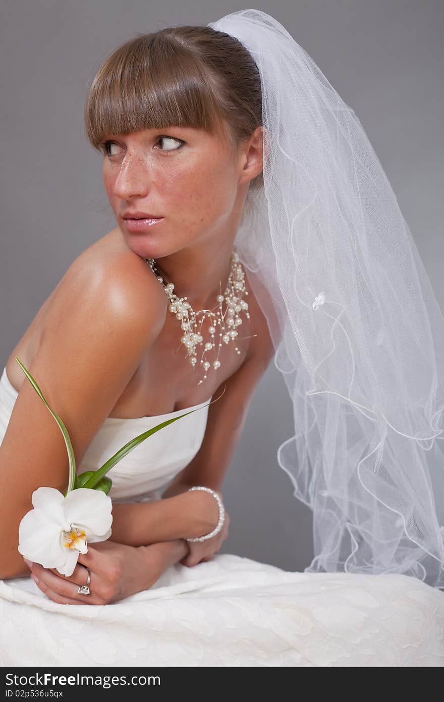 Sensual bride with veil and flower