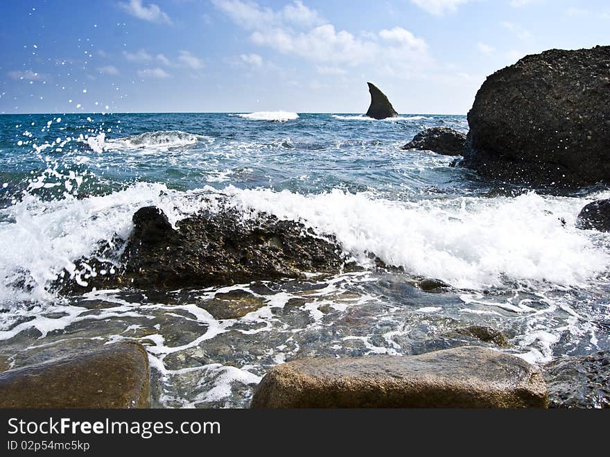 Sea landscape with a shark-like stone