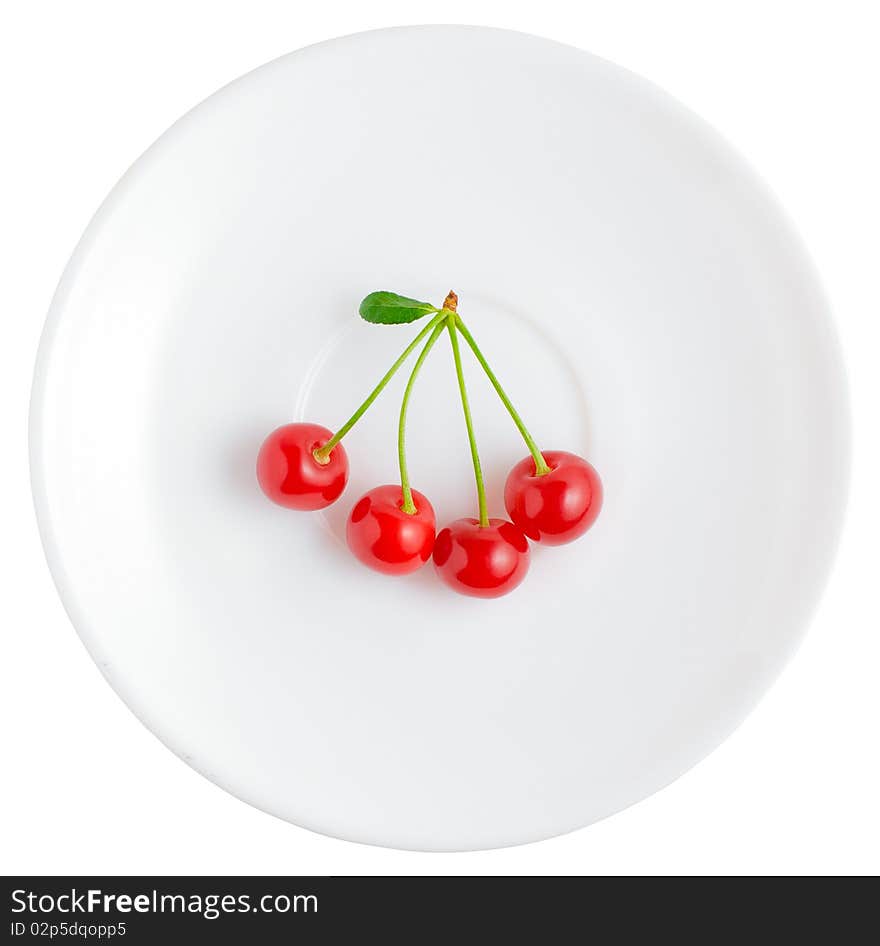 Simple white saucer with four fresh and red cherries. Isolated on white background. Simple white saucer with four fresh and red cherries. Isolated on white background