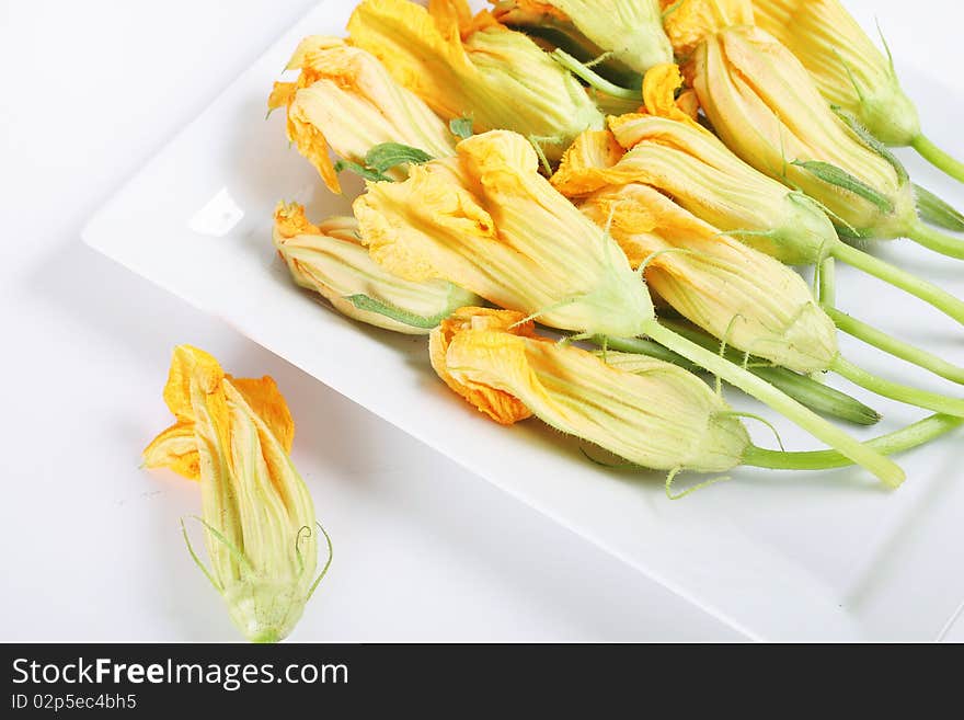 Shot of a plate of fresh squash blossoms from the market