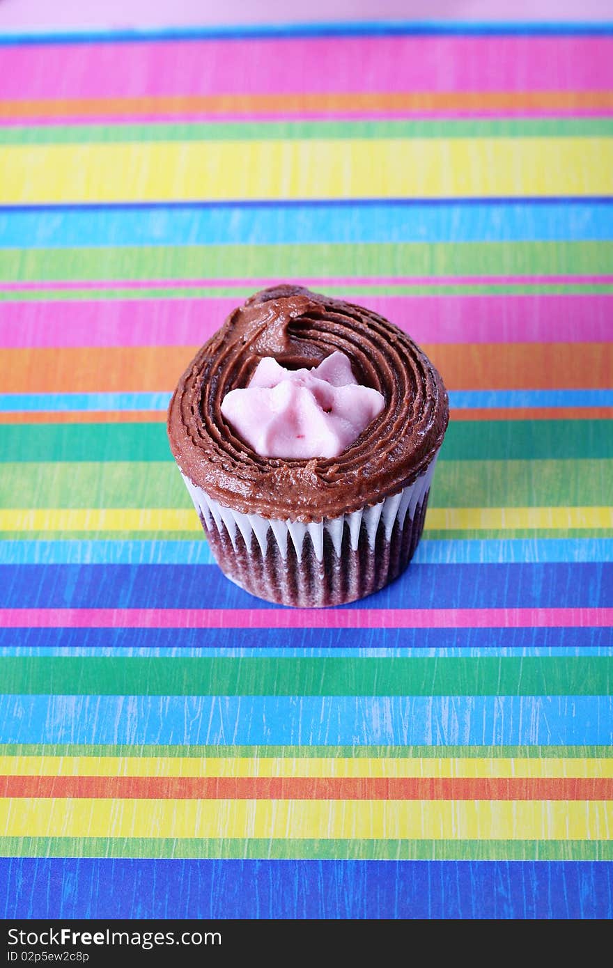 Shot of raspberry filled cupcake on colorful background