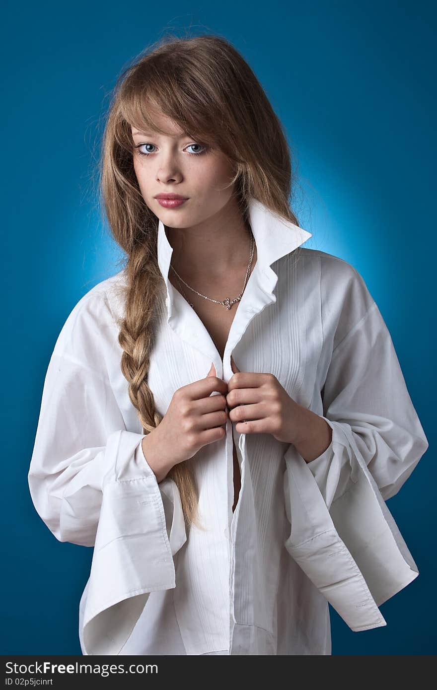 Portrait of the beatiful girl-teenager In a white shirt. Portrait of the beatiful girl-teenager In a white shirt