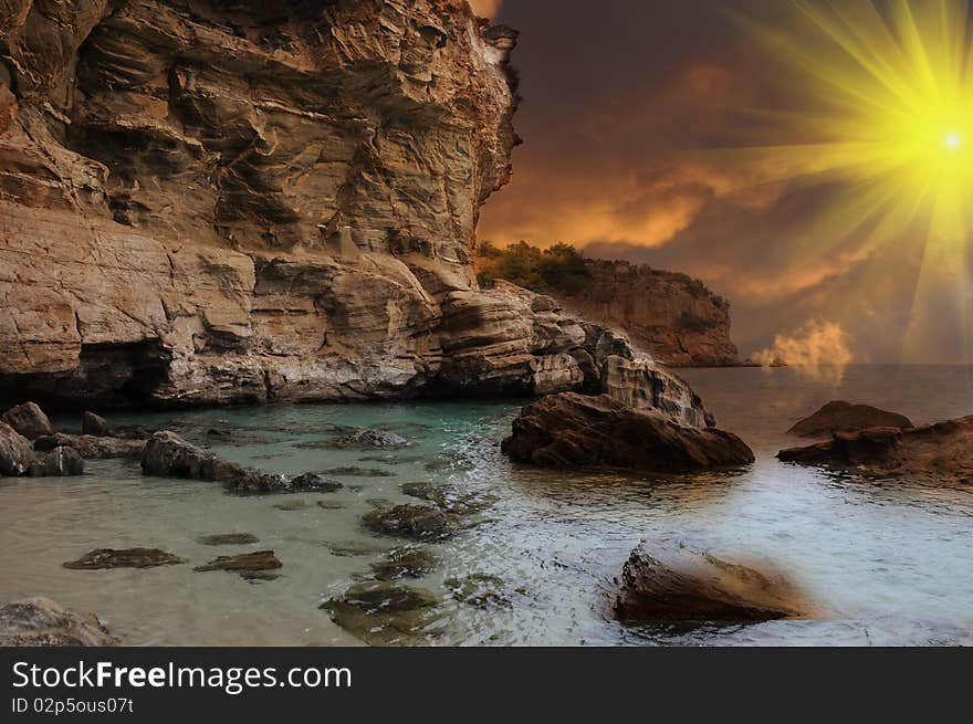 Island in Greece on a cloudy day with sun rays piercing the sky. Relaxing scenery with cliffs. Island in Greece on a cloudy day with sun rays piercing the sky. Relaxing scenery with cliffs